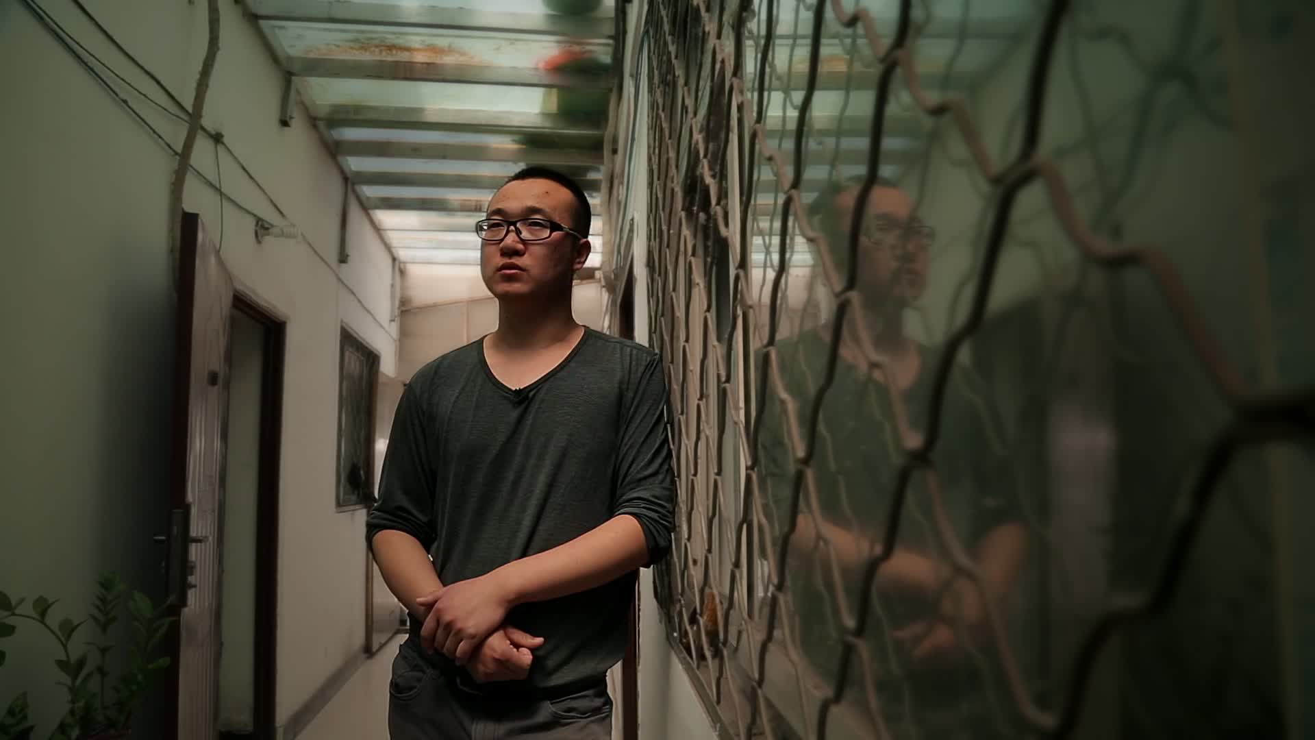 The Interview and Lighting Reel’s actual poster: a man beside a window, his reflection visible in the glass.